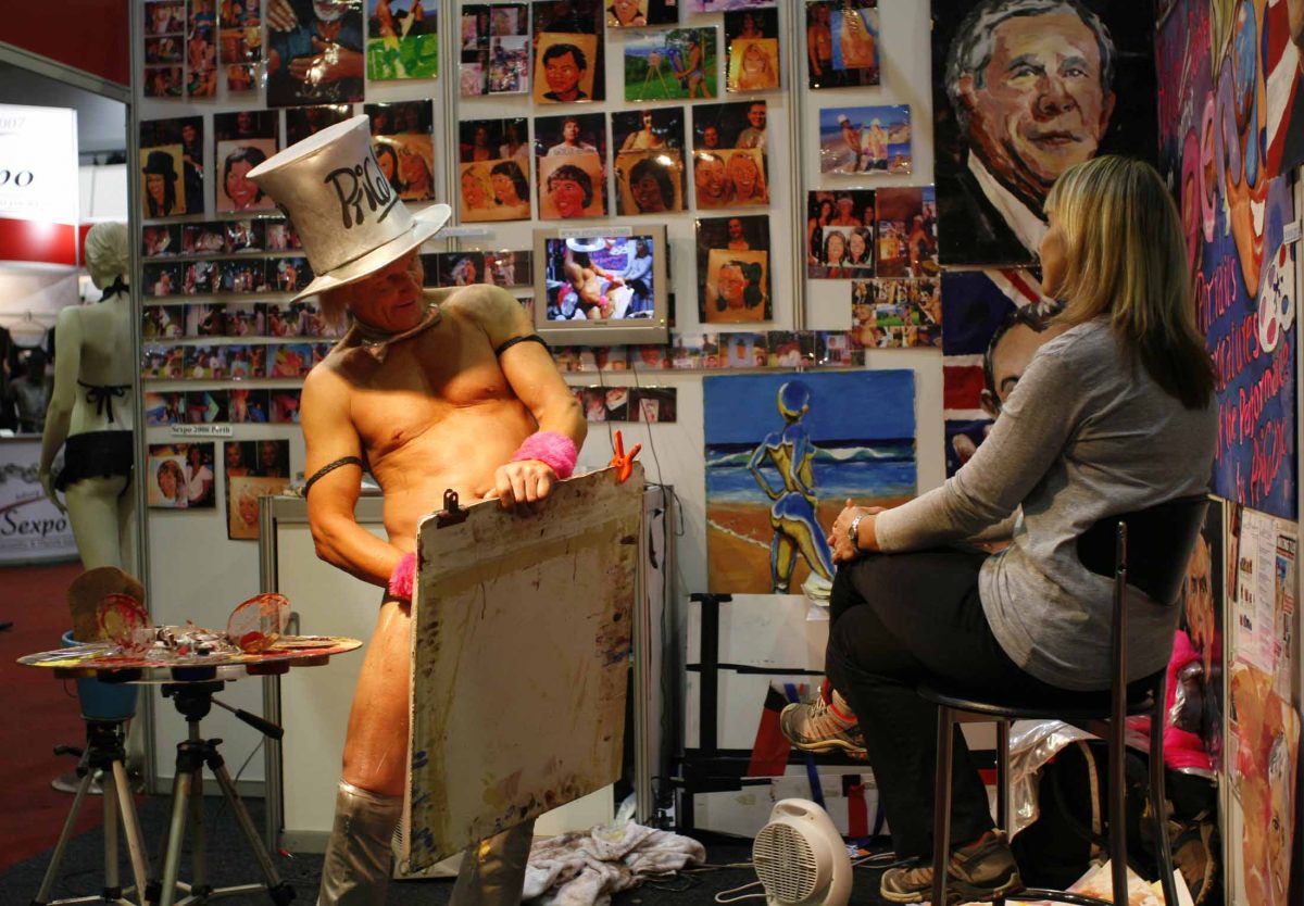 sexpo Artist Tim Patch (L), who calls himself 'Pricasso', shows off his portrait of Olga Braude (R) which he painted with his penis at the Sexpo in Johannesburg, September 28, 2007. Patch has painted portraits of some of the worlds most famous people including George Bush and Queen of England. Antony Kaminju (SOUTH AFRICA)